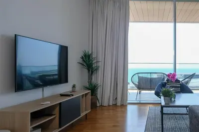 a living room with a flat screen tv at Mira Holiday Homes - Luxury 1 bedroom with sea view in Dubai