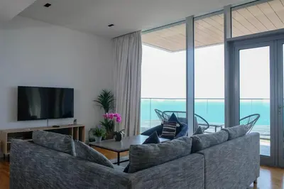 a living room with a couch and a television at Mira Holiday Homes - Luxury 1 bedroom with sea view in Dubai