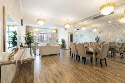 a dining room with a table and chairs at Royal Marina Experience Lavish 2BR Waterfront View in Dubai