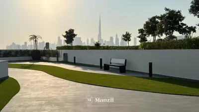 a park with a bench next to a white wall at 1BR Apt Near Downtown Dubai with Pool & Skyline Views in Dubai