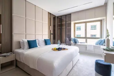 a bedroom with a large bed with a tray of fruit on it at Frank Porter - Al Samar 1 in Dubai