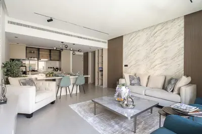 a living room with a couch and a table at Frank Porter - Al Samar 1 in Dubai