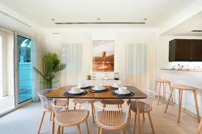 a dining room with a table and chairs at Beautiful 2BR Villa in JVT in Dubai