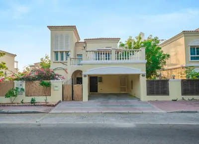 a large house with a balcony on top of it at Beautiful 2BR Villa in JVT in Dubai