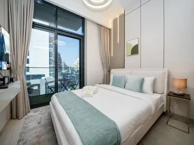 a bedroom with a large bed and a large window at Elegant Studio in Azizi Riviera with Luxury Amenities in Dubai