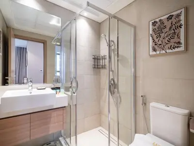 a bathroom with a shower and a toilet and a sink at Elegant Studio in Azizi Riviera with Luxury Amenities in Dubai