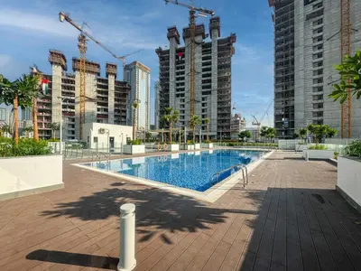 a large swimming pool in a city with tall buildings at Elegant Studio in Azizi Riviera with Luxury Amenities in Dubai