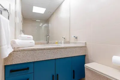 a bathroom with a sink and a mirror at JLT Nice Studio apartment High floor View in Dubai