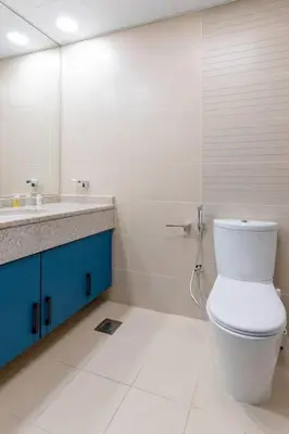 a bathroom with a toilet and a sink and a mirror at JLT Nice Studio apartment High floor View in Dubai