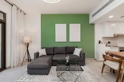a living room with a couch and a table at Asayel Apartments in Dubai