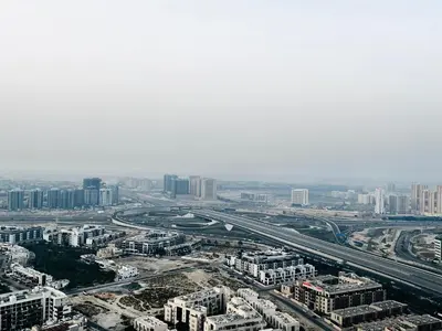 an aerial view of a city with buildings and roads at Top Floor Luxurious Apt in JVC, Near Marina in Dubai