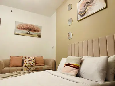 a bedroom with a bed and a couch at Aesthetically Designed Lavish Apt, Near Marina in Dubai