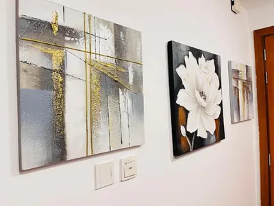 three pieces of art hanging on a wall at Aesthetically Designed Lavish Apt, Near Marina in Dubai