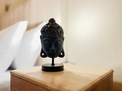 a black mask sitting on a wooden table at Aesthetically Designed Lavish Apt, Near Marina in Dubai