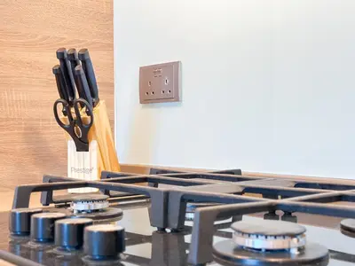a stove top with a pair of scissors on it at Super Luxury Flat Desing with Sea, Marina and Pool View in Dubai