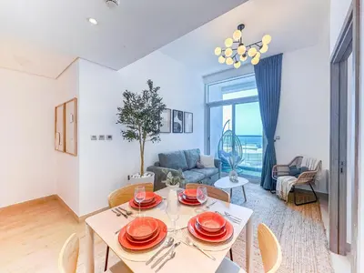 a living room with a table and a couch at Super Luxury Flat Desing with Sea, Marina and Pool View in Dubai