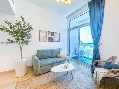 a living room with a couch and a table at Super Luxury Flat Desing with Sea, Marina and Pool View in Dubai