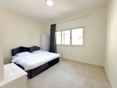 a bedroom with a bed and a window at Barsha Star Residence 2-HomeStay in Dubai