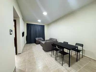 a living room with a table and a couch at Barsha Star Residence 2-HomeStay in Dubai