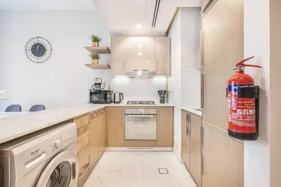a kitchen with a washer and dryer in it at Bright & Modern Home with Burj Khalifa Views in Dubai