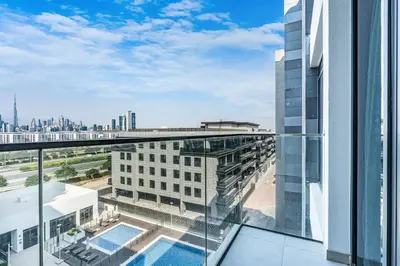 a view from the balcony of a building with a swimming pool at Bright & Modern Home with Burj Khalifa Views in Dubai