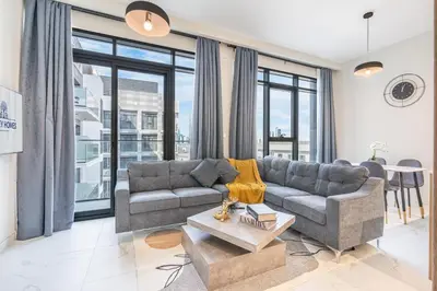 a living room with a couch and a table at Bright & Modern Home with Burj Khalifa Views in Dubai