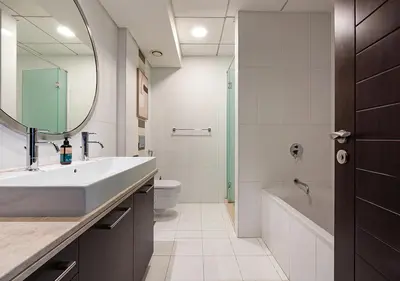 a bathroom with a sink and a tub and a mirror at Luxurious 2-bedroom Apartment in Downtown with Burj Khalifa View in Dubai