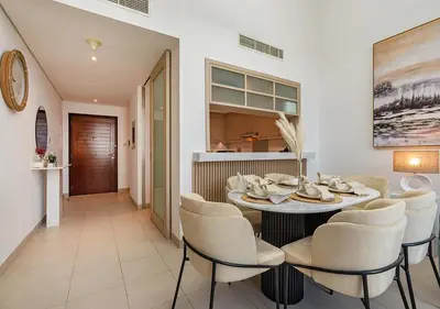a dining room with a table and chairs at Luxurious 2-bedroom Apartment in Downtown with Burj Khalifa View in Dubai