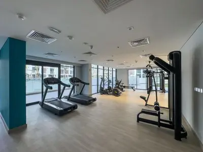 a gym with treadmills and ellipticals in a building at GuestReady - Elegant living in Downtown Dubai in Dubai