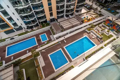 an overhead view of two swimming pools in a city at GuestReady - Elegant living in Downtown Dubai in Dubai