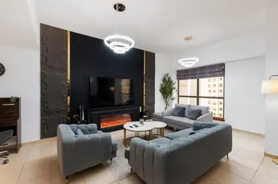 a living room with two couches and a fireplace at Sadaf 5, Jumeirah Beach Residence, JBR - Mint Stay in Dubai
