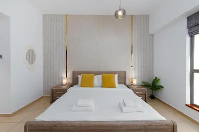 a bedroom with a large bed with yellow pillows at Sadaf 5, Jumeirah Beach Residence, JBR - Mint Stay in Dubai