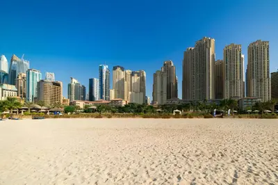 a city skyline with a sandy beach in front of a city at Sadaf 5, Jumeirah Beach Residence, JBR - Mint Stay in Dubai