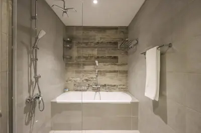 a bathroom with a shower and a sink at Livbnb-Premium 1B with BurjAlArab Views in Mina in Dubai