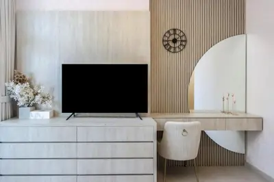 a living room with a tv on a dresser at Livbnb-Premium 1B with BurjAlArab Views in Mina in Dubai