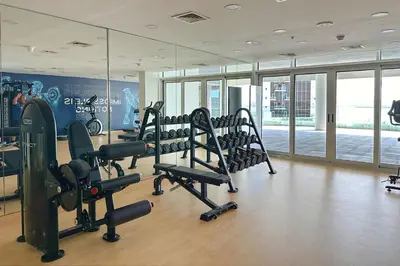 a gym with treadmills and ellipticals in a building at Livbnb-Premium 1B with BurjAlArab Views in Mina in Dubai