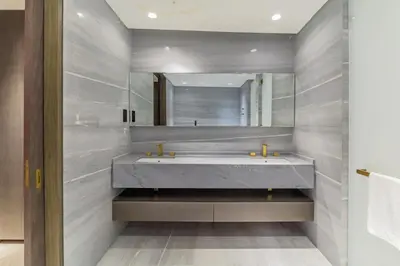 a bathroom with a large sink and a mirror at Luxury 3BDR Apartment, Pool & Beach Access in Dubai