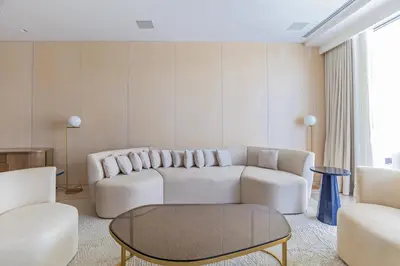 a living room with a white couch and a table at Luxury 3BDR Apartment, Pool & Beach Access in Dubai