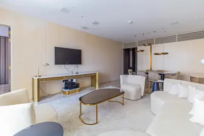 a living room with a couch and a tv at Luxury 3BDR Apartment, Pool & Beach Access in Dubai