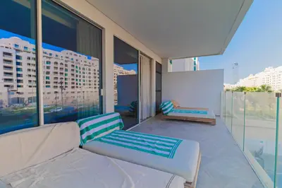 a living room with a couch and some windows at Luxury 3BDR Apartment, Pool & Beach Access in Dubai