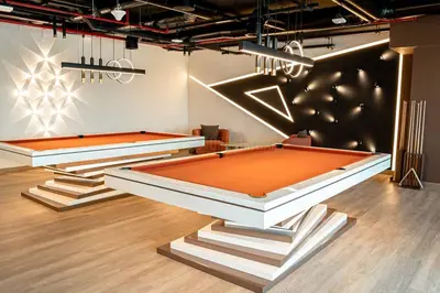 two billiards tables in a room with lights at Luxurious 3Bedroom Apartment in Dubai