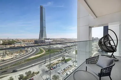 a balcony with a chair and a view of a city at Luxurious 3Bedroom Apartment in Dubai