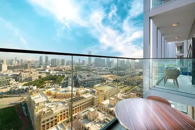 a glass balcony with a view of a city at Lovely Studio in Bloom Tower, 10 minutes to Marina in Dubai