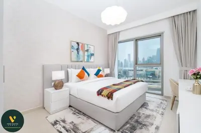 a white bedroom with a large bed and a window at Vogue Downtown Views II with Direct Access to Dubai Mall Via a Climate Controlled Bridge, Three Bedroom Apartment plus kids room and Balcony with Burj Khalifa View in Dubai