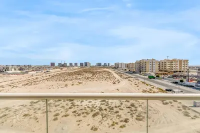a view of a beach with buildings in the background at Waves - Stylish Studio with Balcony in Dubai South in Dubai