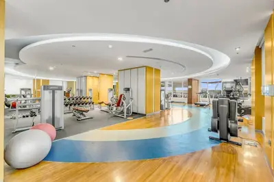 a fitness room with a gym with exercise equipment at Waves - Stylish Studio with Balcony in Dubai South in Dubai