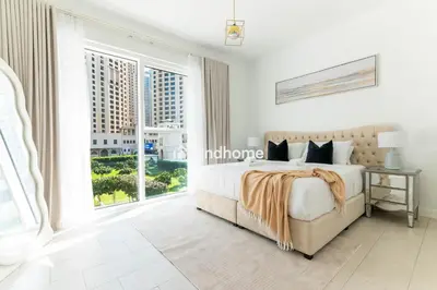 a bedroom with a bed and a large window at La Vie, JBR - Your Perfect Holiday Gateway in Dubai