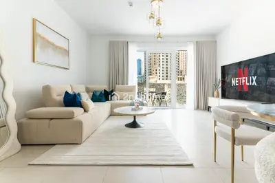 a living room with a couch and a table at La Vie, JBR - Your Perfect Holiday Gateway in Dubai