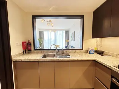 a kitchen with a sink and a large mirror at Modern Elegance in Downtown 1BR with Luxe Decor by Petals Holiday Homes in Dubai