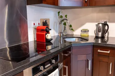 a kitchen with a sink and a red appliance at Luxurious Apartment next to Burj Khalifa and Dubai Mall in Dubai